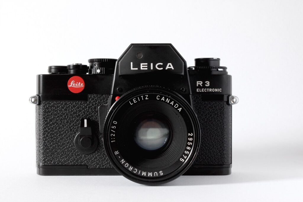Front view of a black Leica R3 electronic camera with a Leitz Canada Summicron 50mm lens.